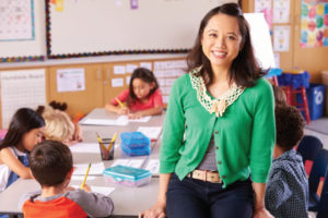 Female teacher standing in front of a class of kids