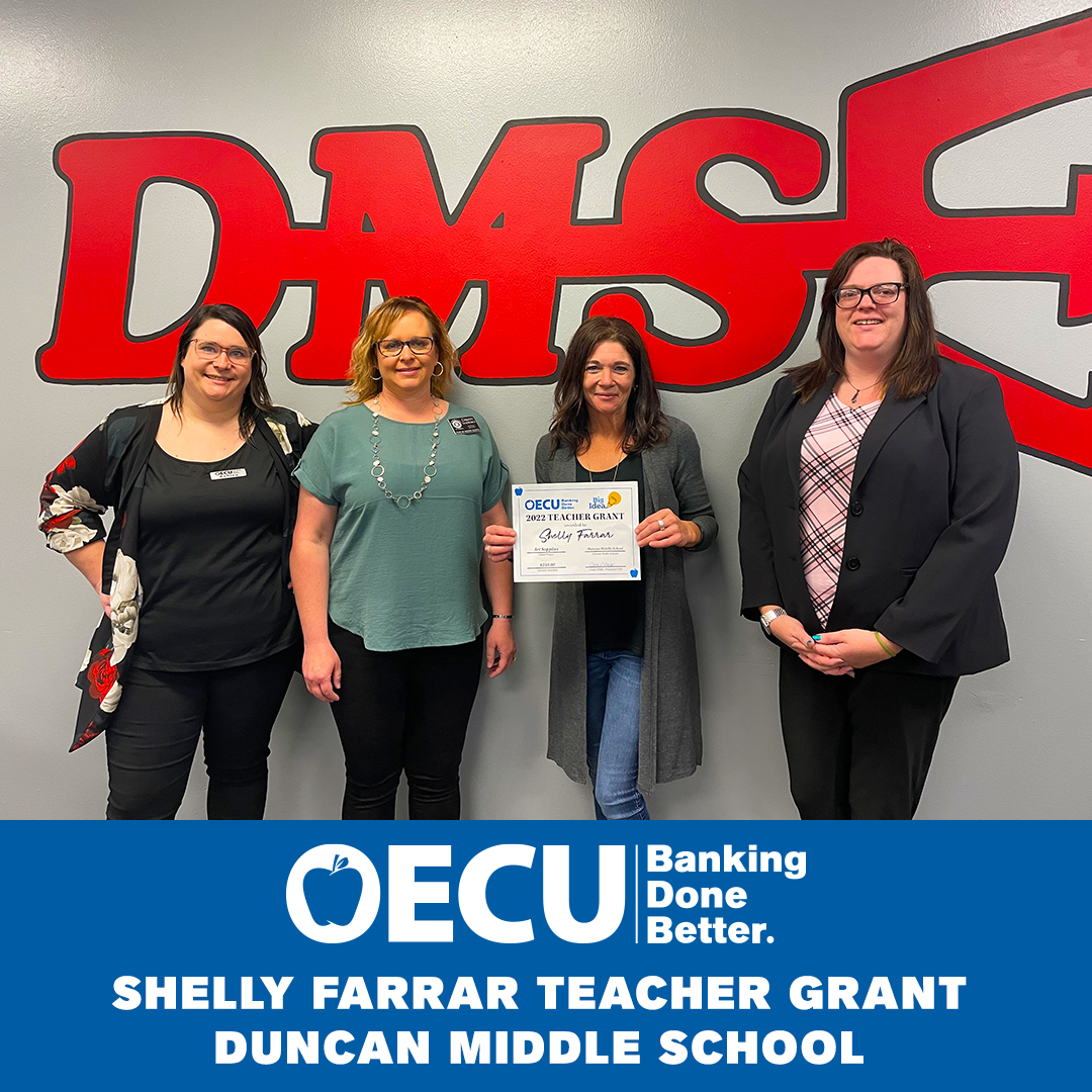 Shelly Farrar, their principal & superintendent receiving teacher grant from an OECU service super star.