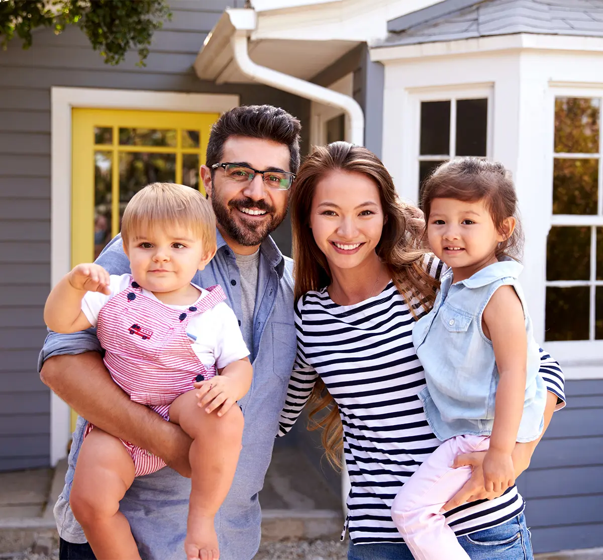 Family Standing outside new home